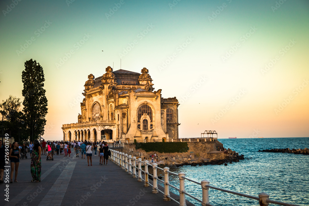 Old casino in Constanta on promenade by the black sea, at the sunset.