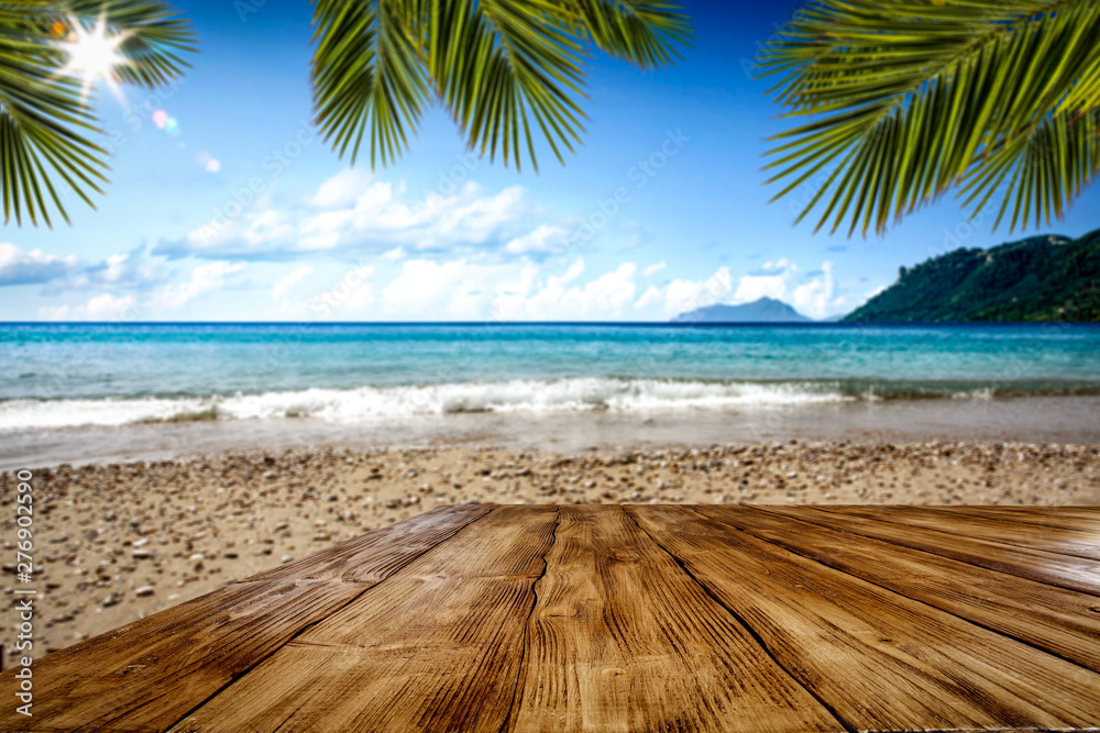 Desk of free space and summer beach background  - obrazy, fototapety, plakaty 