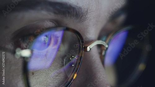 Businesswoman or scientist is working at night via computer girl looking at pc monitor browsing the internet woman focused at result