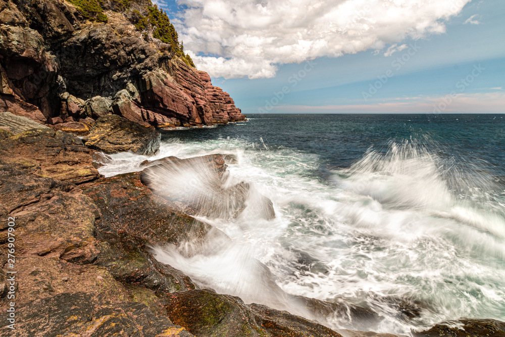 Dramatic seascape with waves crashing on a rocky coast. 