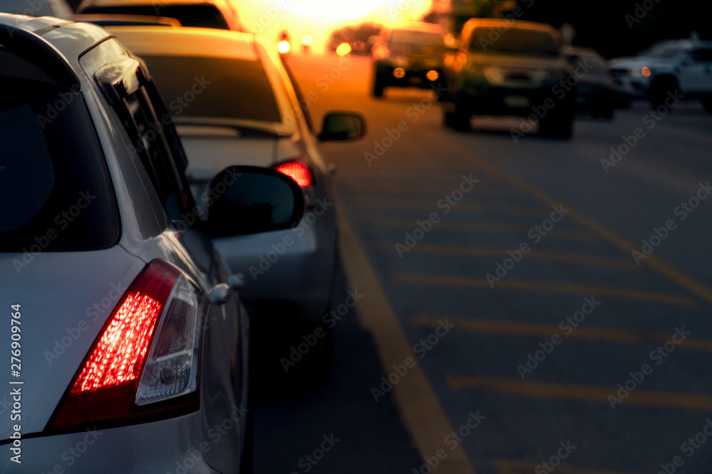 Transportation of cars on the road. Waiting to release traffic signals in the intersection. Heading to travel or work. On the asphalt road. Open light break at evening time.