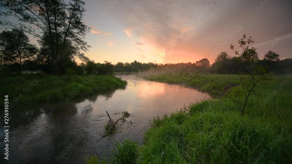 Beautiful summer sunrise over river banks