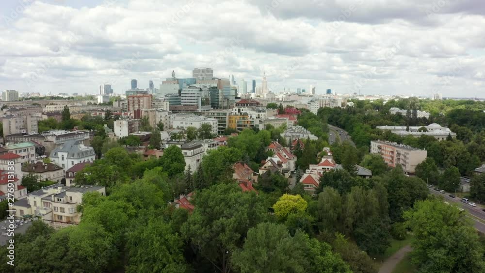 Flying over the roofs of condominium apartment buildings in the direction of the skyscrapers in the city center. Aerial view of the city center of Warsaw / Poland. Shot Drone 4K. Flying over the roofs of condominium apartment buildings in the direction of the skyscrapers in the city center. Aerial view of the city center of Warsaw / Poland. Shot Drone 4K.