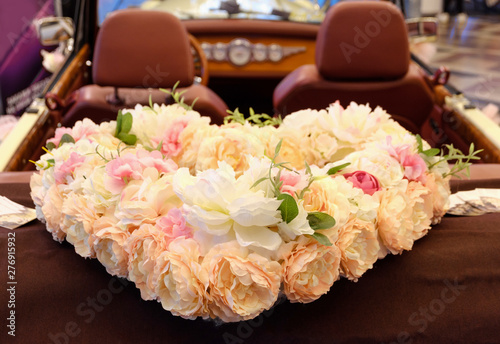 white car decorated with a heart of the flowers