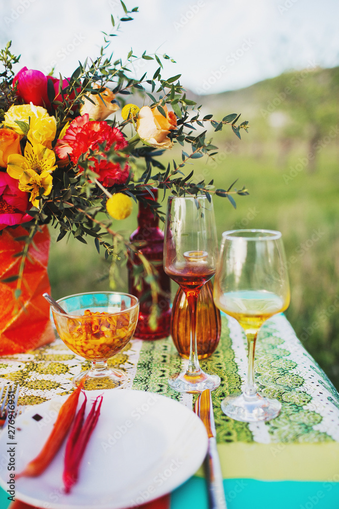 Beautiful outdoor dinner picnic in the nature, plate and wine glass close up. Beautiful outdoor dinner picnic in the nature, plate and wine glass close up.