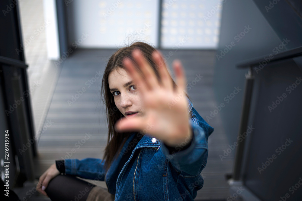 Fototapeta premium Portrait of a young caucasian lady with freckles on club stairs