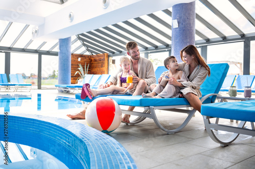 Loving family making a break after swimming pool with a refreshment drink © didesign