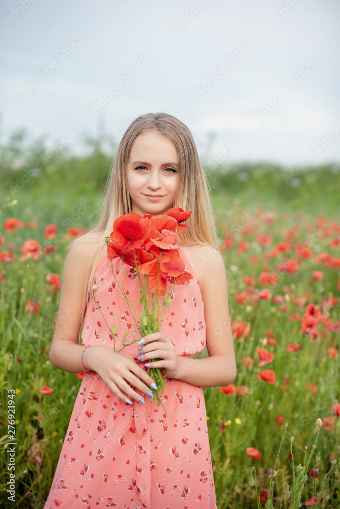 Ukrainian Beautiful girl in field of poppies and wheat. outdoor portrait in poppies Ukrainian Beautiful girl in field of poppies and wheat. outdoor portrait in poppies