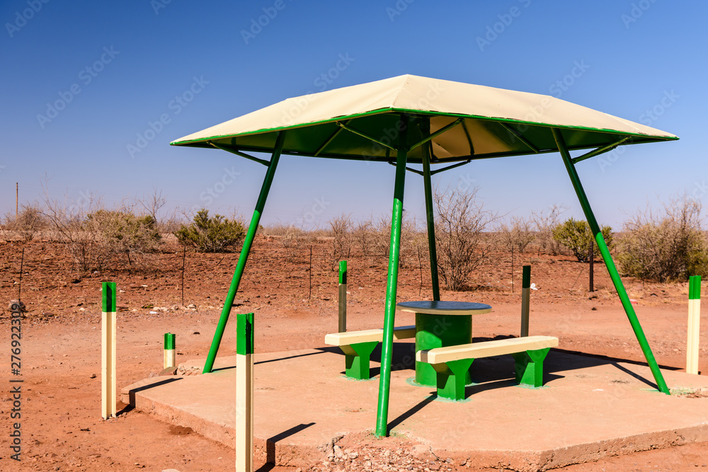 Concrete picnic table and benches with a canopy for shade, typically placed every 10-20kms along roads in Namibia Concrete picnic table and benches with a canopy for shade, typically placed every 10-20kms along roads in Namibia