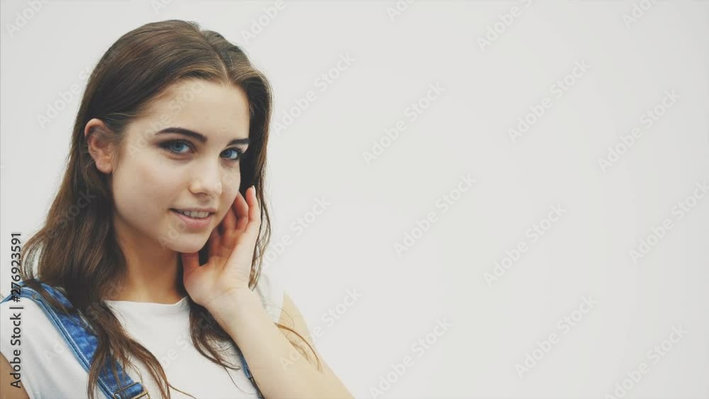 Young beautiful sexy flirting girl, hand on lips, wrapping hair round her finger, looking at the camera. Young beautiful sexy flirting girl, hand on lips, wrapping hair round her finger, looking at the camera.
