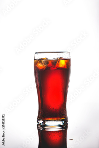 glass of cola, lemonade with ice on a white background