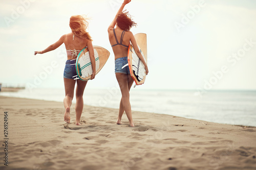 Photography Surfers on beach having fun in summer