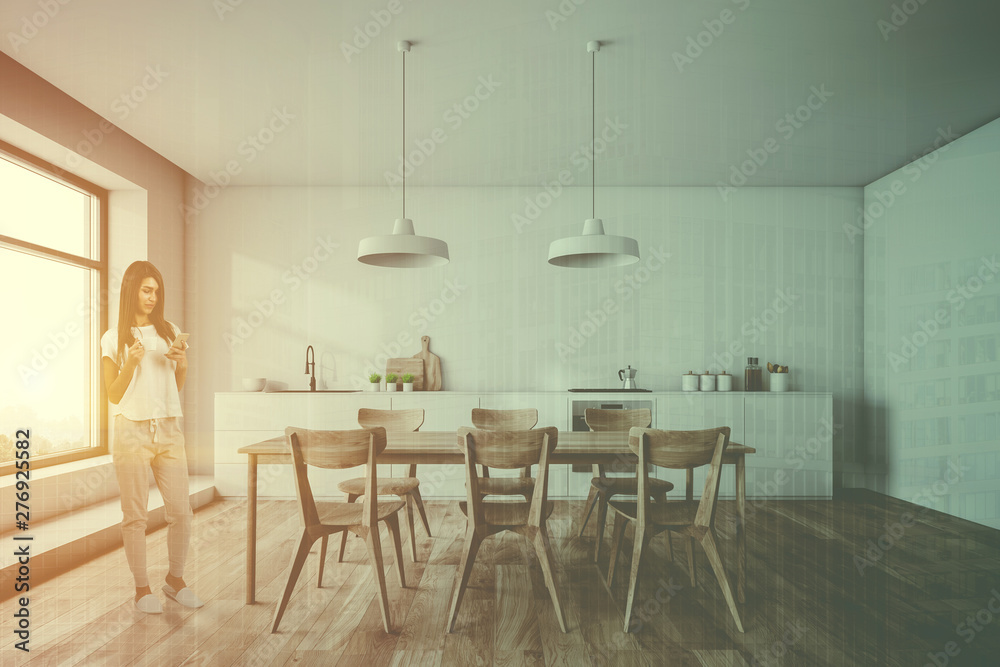 Woman in white kitchen with table