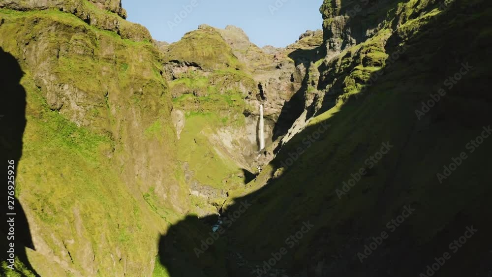 Aerial: Spectacular Mulagljuvur Canyon covered in moss at the foot of Glacier in Iceland. Beautiful sunny day.