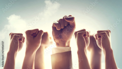 Hands of Business team raised fist air Corporate Celebration victory, success and winning concept. sunlight effect.