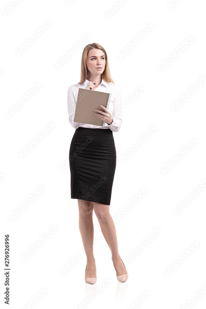 Pensive blonde woman writing in copybook, isolated Pensive blonde woman writing in copybook, isolated