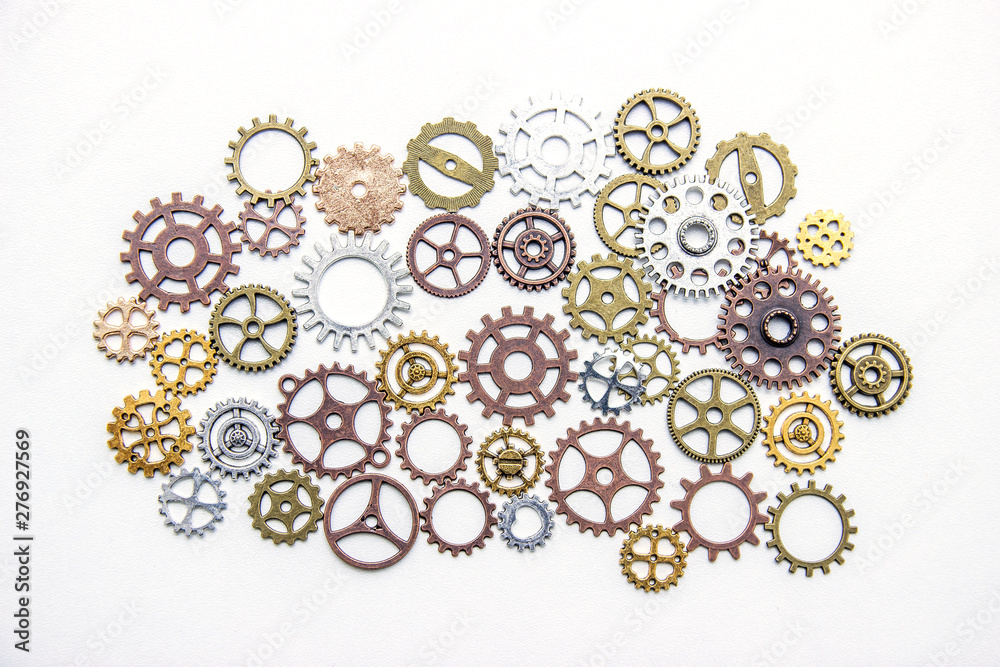 Group of gears on a light background. The background of the gears. Group of gears on a light background. The background of the gears.