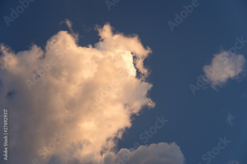 a picture of a  beautiful group of clouds with orange sunlight hat Sunset shine on during twillight.
