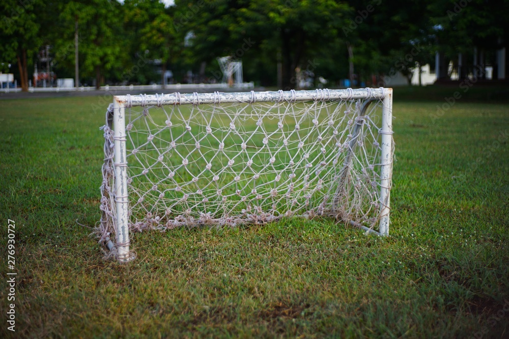 soccer goal with net on green field soccer goal with net on green field