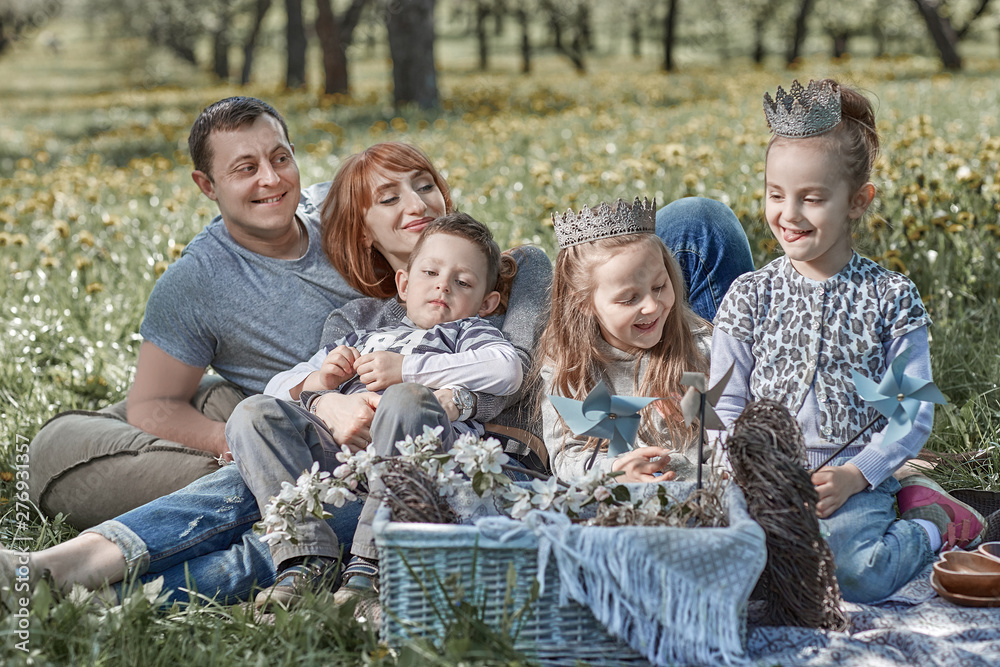 happy family sitting in a clearing during a picnic happy family sitting in a clearing during a picnic