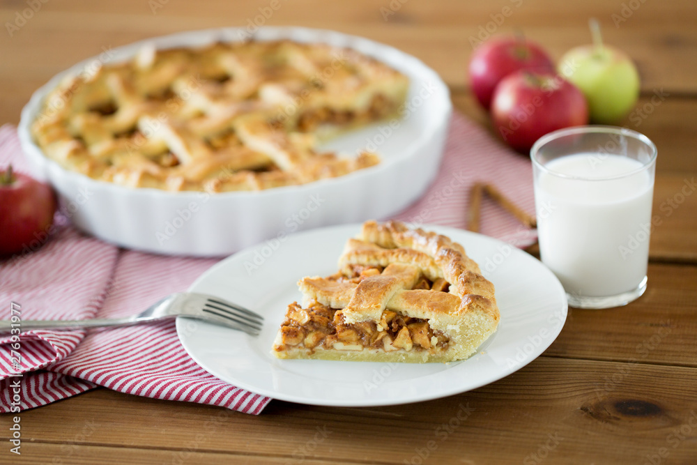 food, culinary and baking concept - close up of apple pie and fork on plate food, culinary and baking concept - close up of apple pie and fork on plate