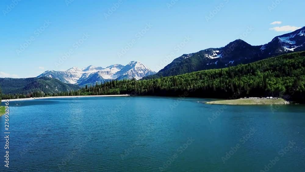 Aerial view of a mountain lake the raising quickly to reveal more of the scene Aerial view of a mountain lake the raising quickly to reveal more of the scene