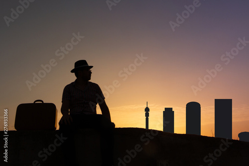 tourist in front of johannesburg skyline in south africa