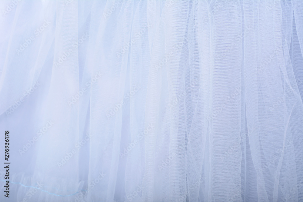 Blue fabric texture background. The skirt is made of tulle