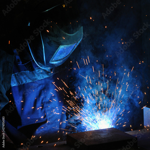 electric welder brews steel at the factory