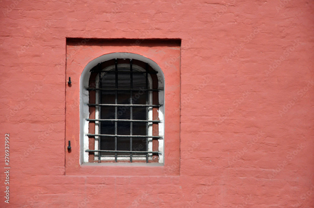 Antique brick wall with an arched window. Texture.