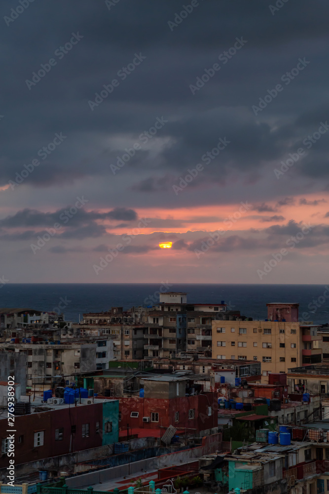 Aerial view of the residential neighborhood in the Havana City, Capital of Cuba, during a colorful and cloudy sunset. Aerial view of the residential neighborhood in the Havana City, Capital of Cuba, during a colorful and cloudy sunset.