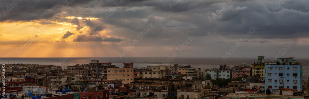 Aerial Panoramic view of the residential neighborhood in the Havana City, Capital of Cuba, during a colorful  and rainy sunset.