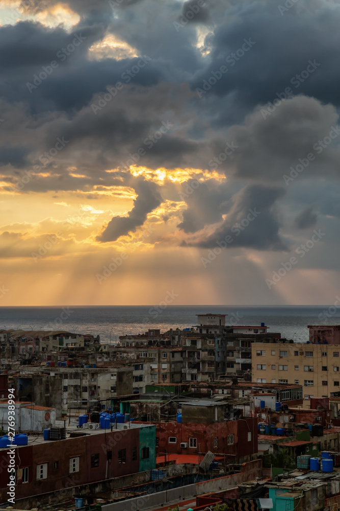 Aerial view of the residential neighborhood in the Havana City, Capital of Cuba, during a colorful and rainy sunset. Aerial view of the residential neighborhood in the Havana City, Capital of Cuba, during a colorful and rainy sunset.