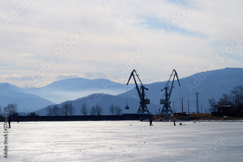 cranes on the background of the mountains in the port