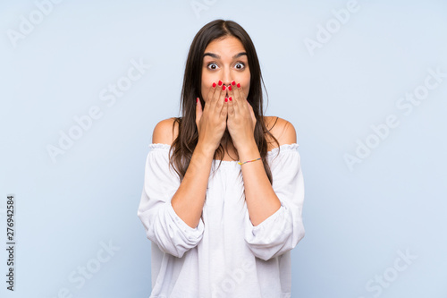 Young woman over isolated blue background with surprise facial expression