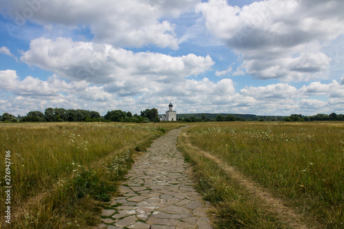 The road leading through the meadow to the Church of the Intercession on the Nerl summer day © Inna