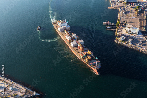 Container cargo ship leaving Long Beach harbor and heading out to the Pacific Ocean.   photo