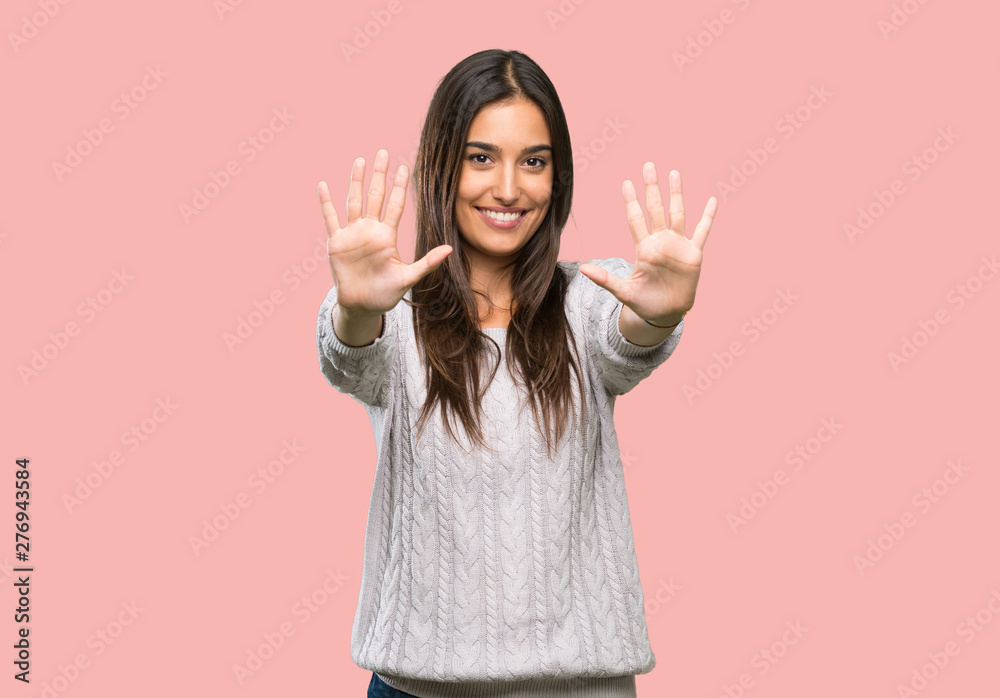 Young hispanic brunette woman counting ten with fingers over isolated background Young hispanic brunette woman counting ten with fingers over isolated background