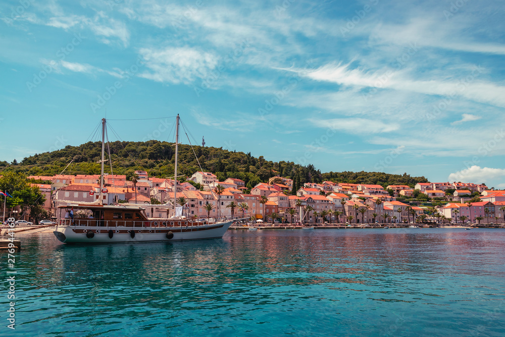 Embankment of Korcula on the island of the same name. Ship in the harbour. Croatia. Summer travel concept.