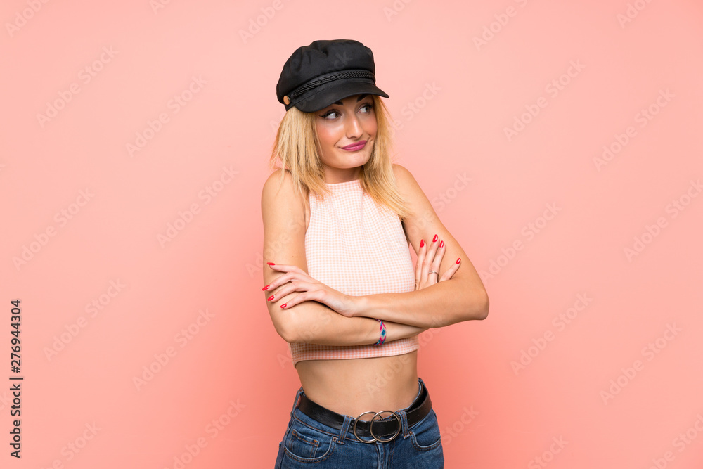 Young blonde woman with hat making doubts gesture while lifting the shoulders Young blonde woman with hat making doubts gesture while lifting the shoulders