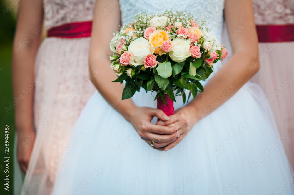 Bride holding bouquet of flowers in the hands
