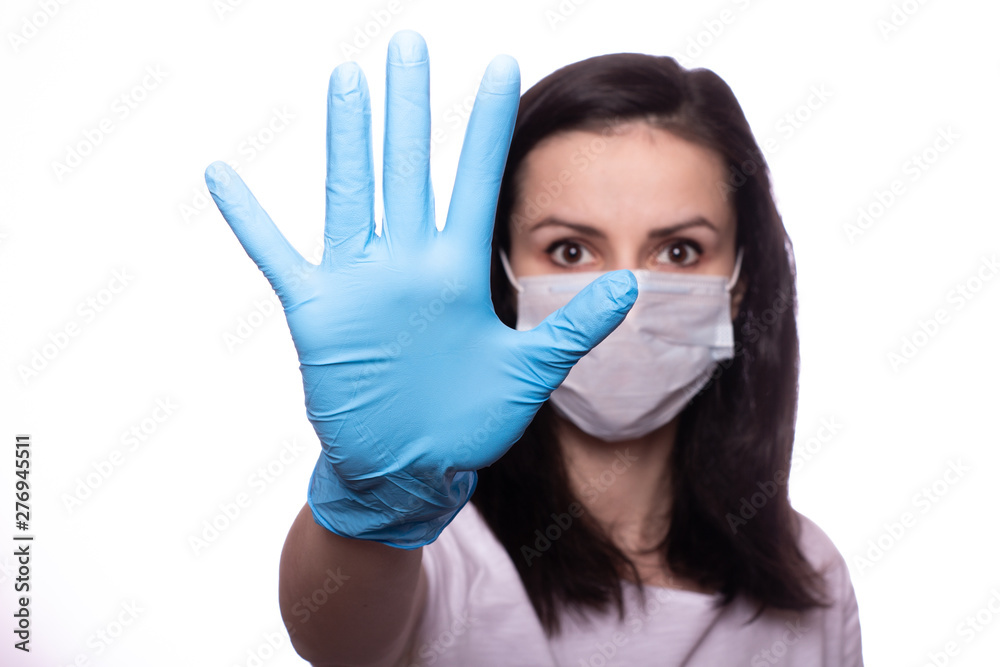 young woman in medical mask on her face, gloves on hands young woman in medical mask on her face, gloves on hands