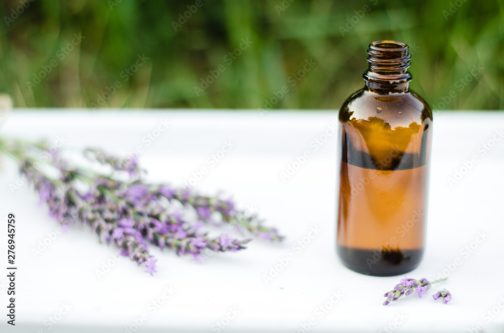 Lavender essential oil. Dark bottle of essential oil with fresh lavender twigs. natural face and body beauty care concept. Lavender essential oil. Dark bottle of essential oil with fresh lavender twigs. natural face and body beauty care concept.