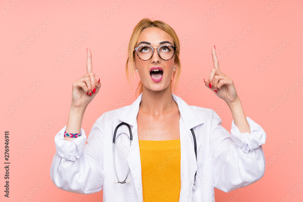 Young blonde doctor woman pointing with the index finger a great idea Young blonde doctor woman pointing with the index finger a great idea