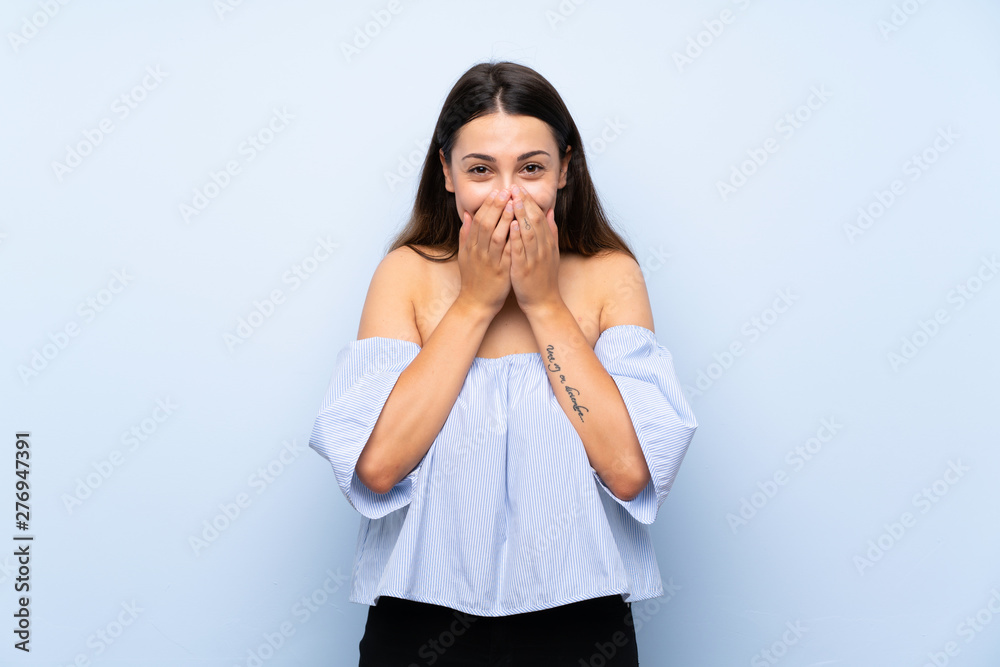 Young brunette woman over isolated blue background with surprise facial expression Young brunette woman over isolated blue background with surprise facial expression