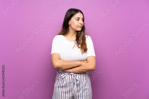 Young woman over isolated purple background portrait