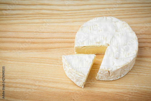 camembert soft cheese on wood background 