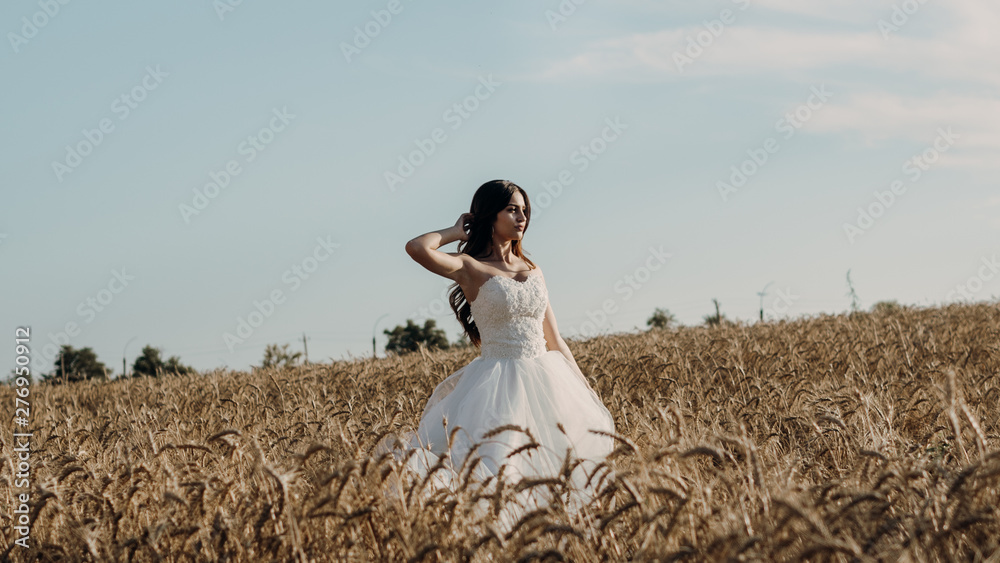 Beautiful bride in wheat field on sunset Beautiful bride in wheat field on sunset