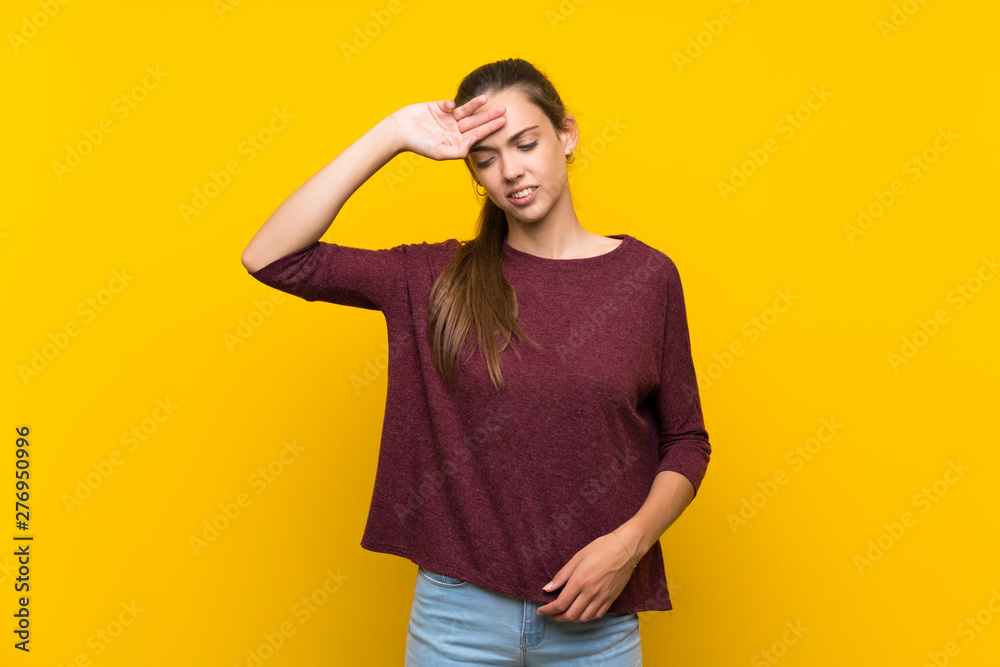 Young woman over isolated yellow background with tired and sick expression Young woman over isolated yellow background with tired and sick expression