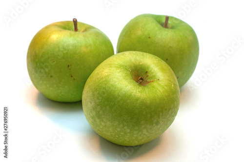 Green ripe granny apples on a white background